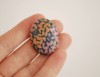 Ovali sagė „Žiedlapių byrėjimas“ (pin13)